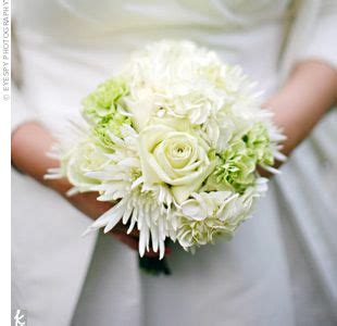 The white wedding centerpiece will never go out of style. all-white bouquet of roses, spider mums, hydrangeas, and ...