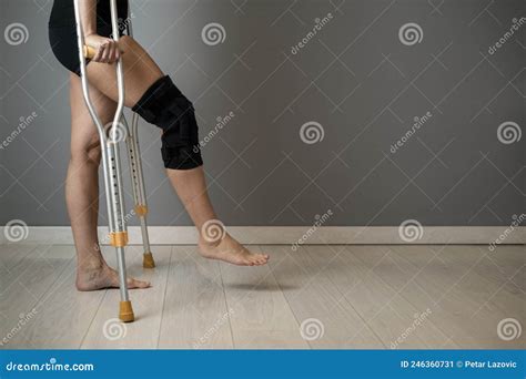Women S Legs With A Knee Brace And Crutches For Rehabilitation After