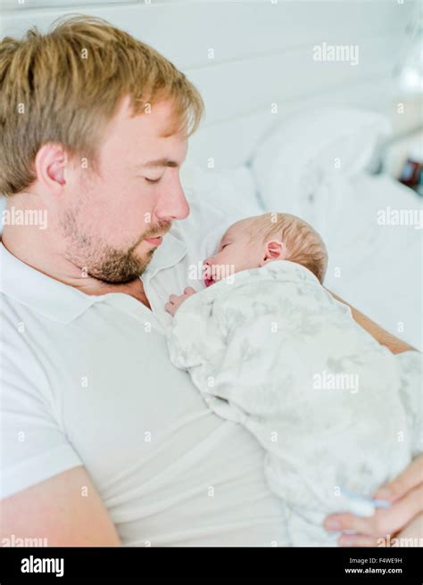 Mid Adult Man Holding Baby Boy 0 1 Months In His Arms Stock Photo Alamy