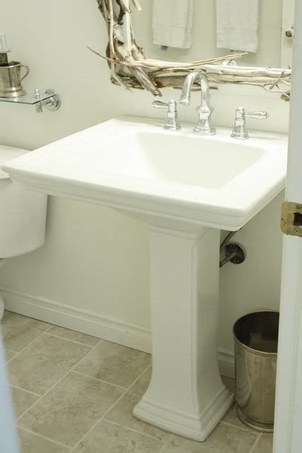 Browse powder room designs and decorating ideas. Powder room with driftwood mirror, glossy white pedestal ...