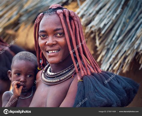 Portrait Of A Young Himba Woman With Her Child Wearing Traditional