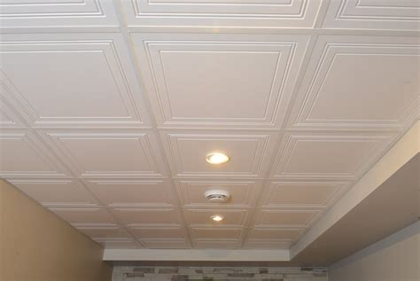 A Room With White Ceiling Tiles And Lights