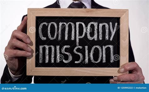 Company Mission Written On Blackboard In Businessman Hands