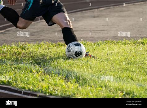 Foot Kicking Soccer Ball On Green Grass Kick The Ball Corner In