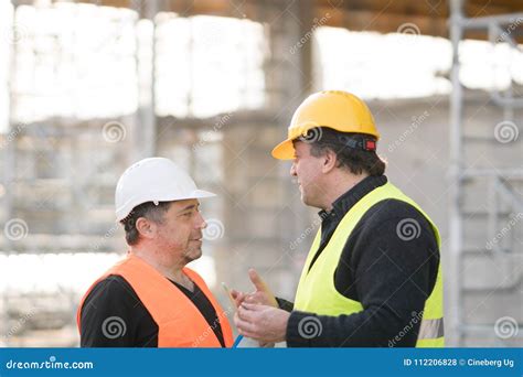 Construction Workers Talking On Construction Site Stock Photo Image