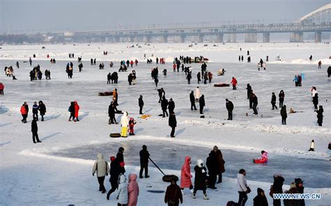 Tourists Play On Frozen Songhua River In Ne Chinas Harbin Cn