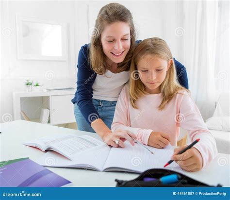 Woman Helping Out Her Little Sister For Homework Stock Image Image Of Pedagogy Notebook 44461887