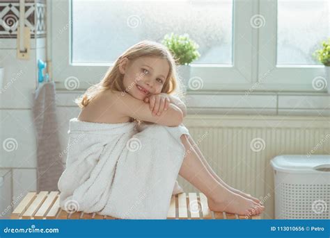 Portrait Of Pretty Little Child Girl With White Towel After Show Stock