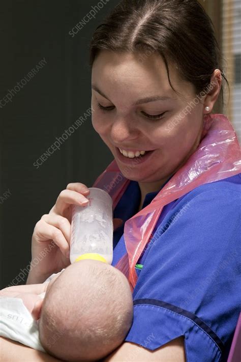Nurses Feeding A Baby Stock Image C Science Photo Library