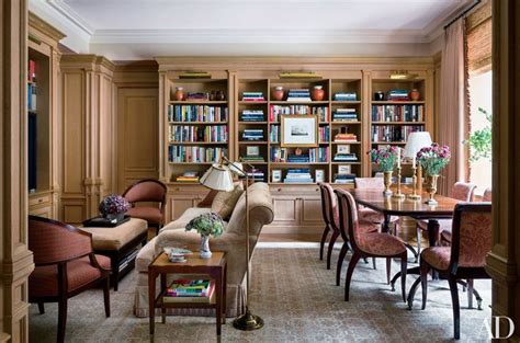 A Living Room Filled With Lots Of Furniture And Bookshelves Covered In