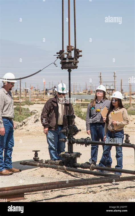 A Federal Bureau Of Land Management Team Inspects Pump Jacks In The