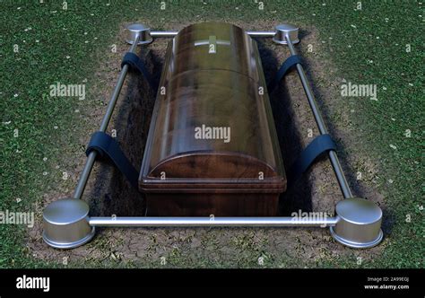 A Modern Wooden Coffin At A Funeral Being Lowered Into A Grave With A