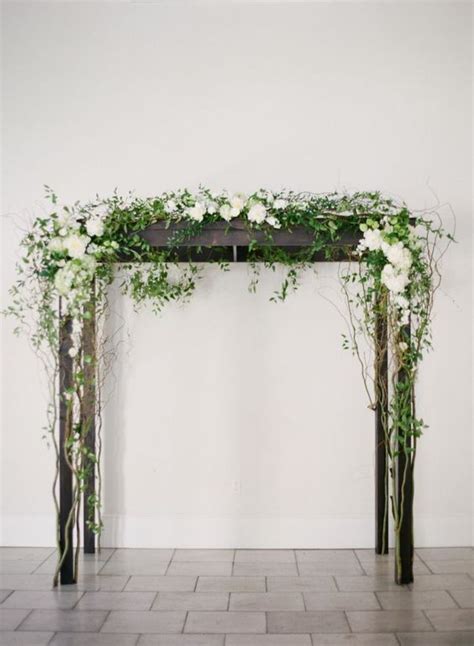 Dark Wood Arbor Decorated With White Flowers And Greenery Wedding Arch