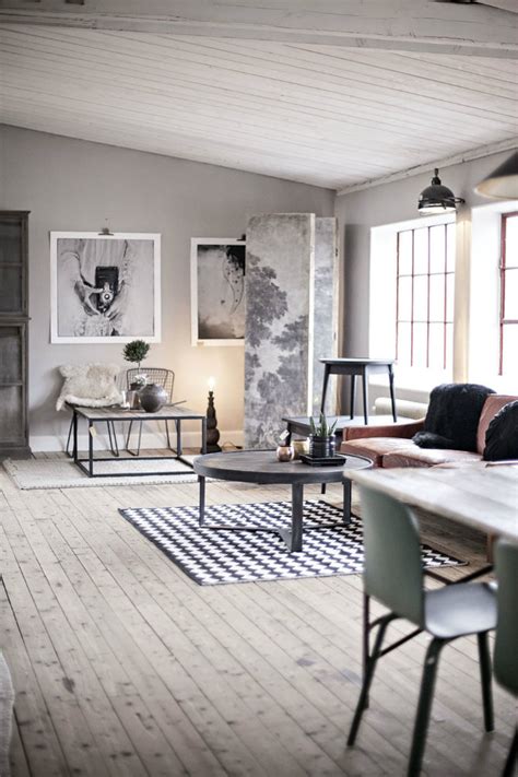 Polished concrete holds terracotta leather met by white and wooden tables, their steel legs tying in modern create a sense of luxury in the industrial style. 10 industrial style living room ideas for an incredible home