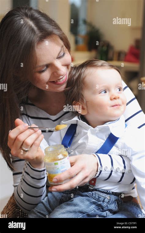 Woman Feeding Toddler Son Baby Food Stock Photo Alamy