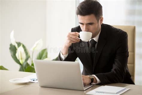 Businessman Drinking Coffee When Working In Office Stock Photo Image