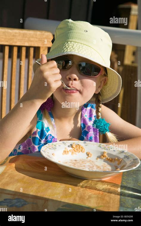 Girl Eating Cereal For Breakfast Stock Photo Alamy