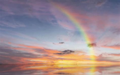 Rainbow At Sunset And Sun Beam On Blue Pink Sky Yellow Clouds Skyline