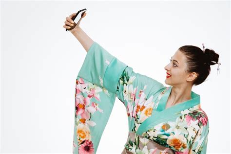 Premium Photo Woman In Traditional Japanese Kimono Taking Selfie Using Smartphone Happy And