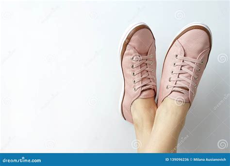 Female Feet In Pink Snickers On White Background Brand New Pink Shoes
