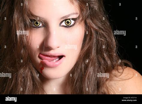 Scary Woman With Wolf Eyes Licking Her Lips Stock Photo