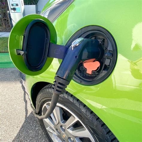 A Lime Green Electric Vehicle Charging At A Free Public Charging
