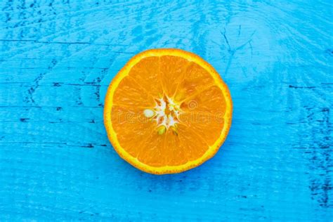 Slice Of Orange Fruit On The Rustic Blue Background Stock Image Image
