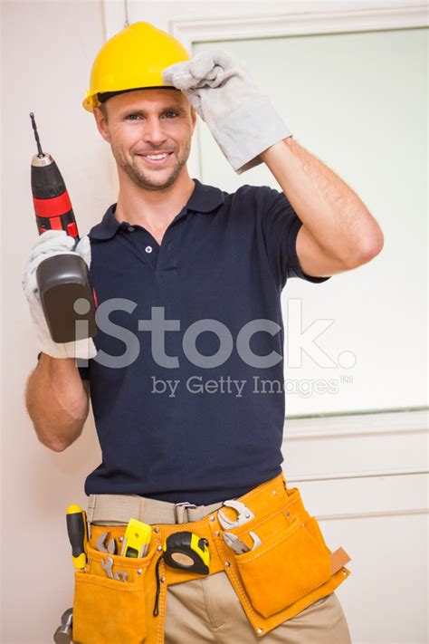 Construction Worker Posing While Holding Power Tool Stock Photo