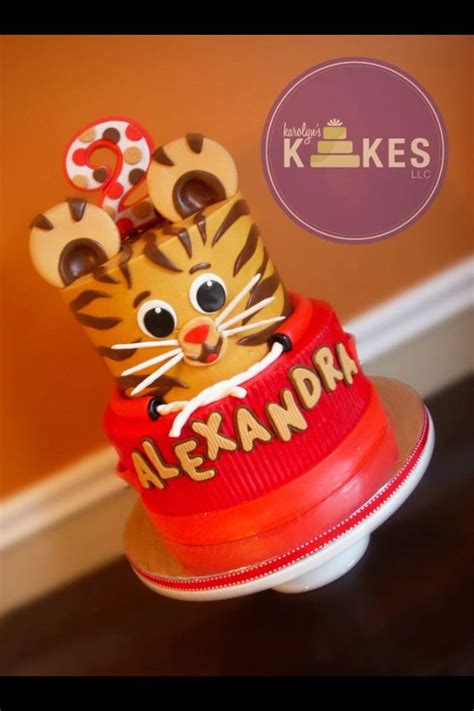 daniel tiger cake both tiers are iced in buttercream decorations and topper are marshm