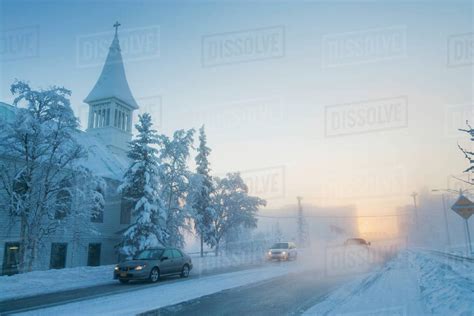 Vehicle Traffic In Ice Fog In Downtown Fairbanks During Winter