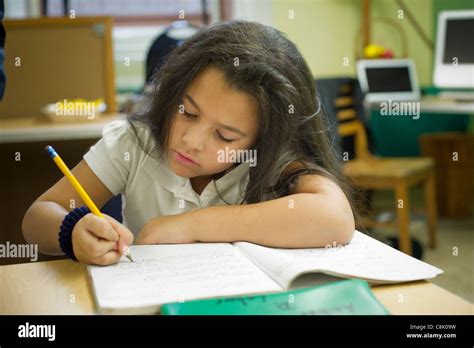 Second And Third Graders Do Homework During An After School Program In