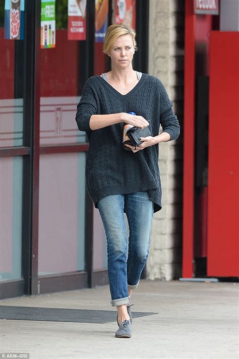 She wore a dark grey jumper, black coat and jeans, and she hid her new hairstyle with a knitted hat. 10 Pictures of a Charlize Theron without Makeup