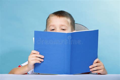 Child Boy Kid Reading A Book On Blue Stock Photo Image Of Intelligent