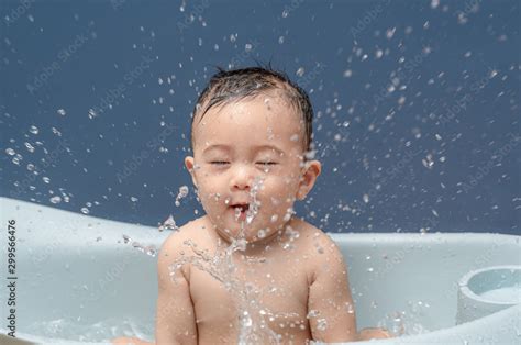 Cute Baby Boy Bathes In A Bathtub Play And Making Splash Water Drops