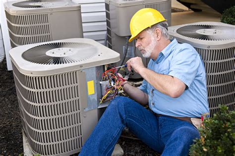 A Contractor Works On Repairing An Hvac Unit For A Central Air