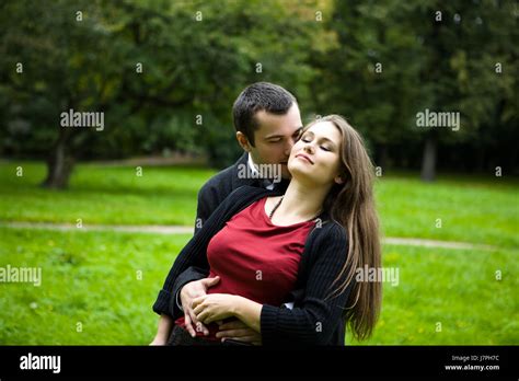 Two Young Lovers Enjoying Each Other In Park Stock Photo Alamy