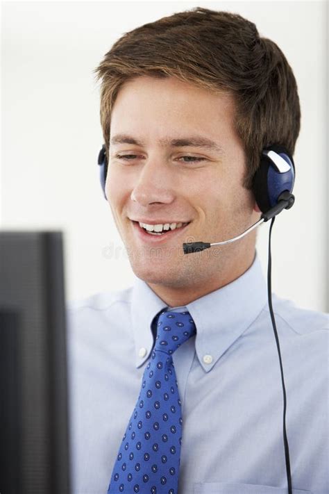 Friendly Service Agent Talking To Customer In Call Centre Stock Image