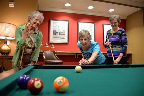 Girls Playing Pool Retirement Living Associates