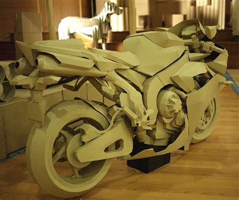 You can glue the motorbike to a heavier piece of cardboard or small piece of wood to use as a stand. papercraft - cardboard motorcycle on Behance