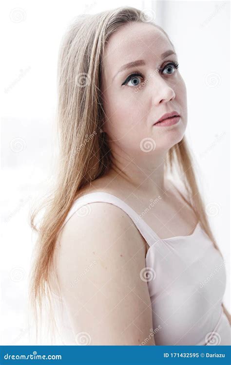 Close Up Headshot Portrait Of Young Attractive Woman With Tranquil Expression On Her Face Stock