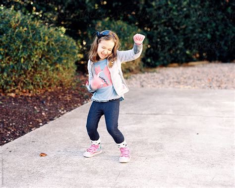 Cute Young Girl Dancing Outside By Stocksy Contributor Jakob