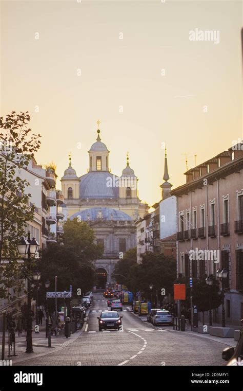 Road With Cars On A Street In Madrid With Important Building At Sunset