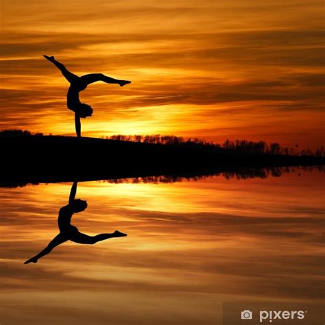 Wall Mural Silhouette Of Female Gymnast Doing A Handstand In Sunset