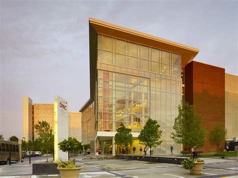 A Large Glass Building With People Walking Around It