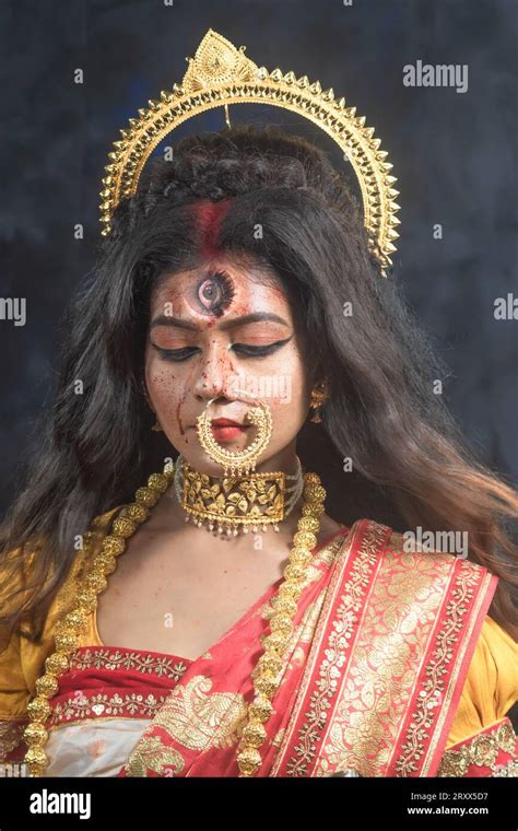 portrait of beautiful indian girl of durga idol agomoni concept indoor photo wearing traditional
