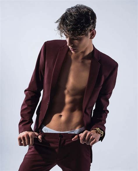 A Shirtless Man In A Maroon Suit