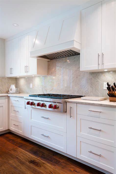 Taj mahal quartzite features a soft white background and subtle gold veins. Bright white cabinets with Taj Mahal quartzite counters ...