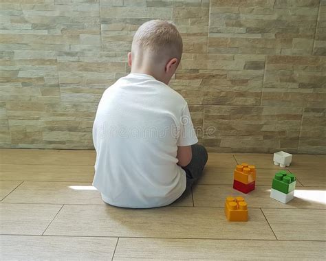 Little Sad Boy Sitting On The Floor With A Block Depression Frustrated