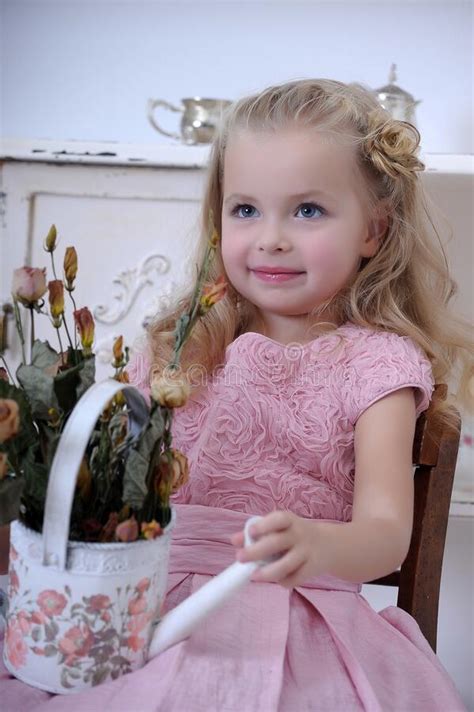Cute Little Blonde Girl In A Pink Dress With Curls Stock Image Image