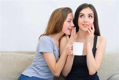 Two Happy Friends Talking And Drinking Coffee And Tea And Gossiping